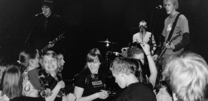 Black and white photo of a band playing on stage